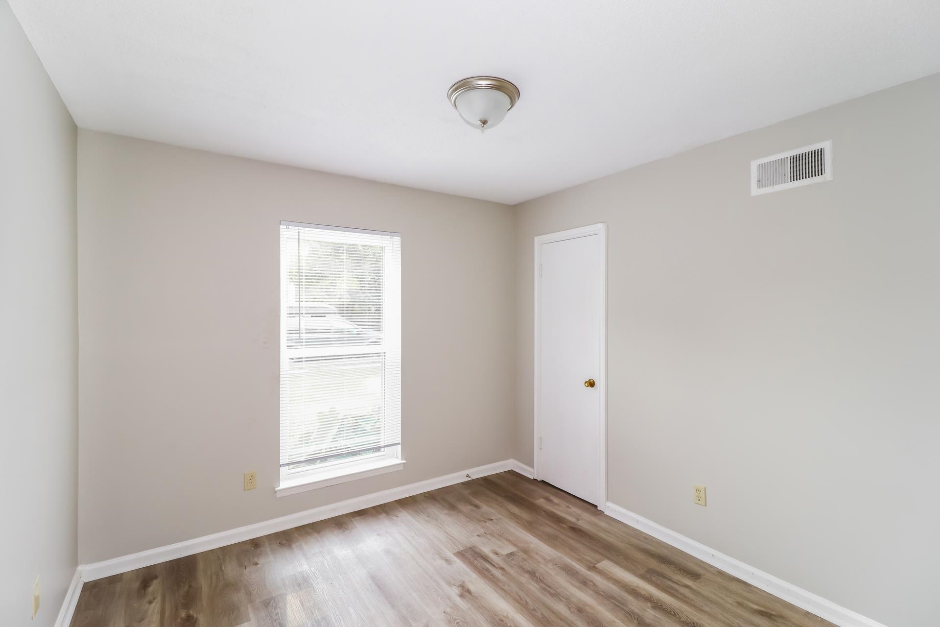 4442 Old Quarry Road Memphis, TN 38118 - Photo 13 of 16 a view of an empty room with wooden floor and a window