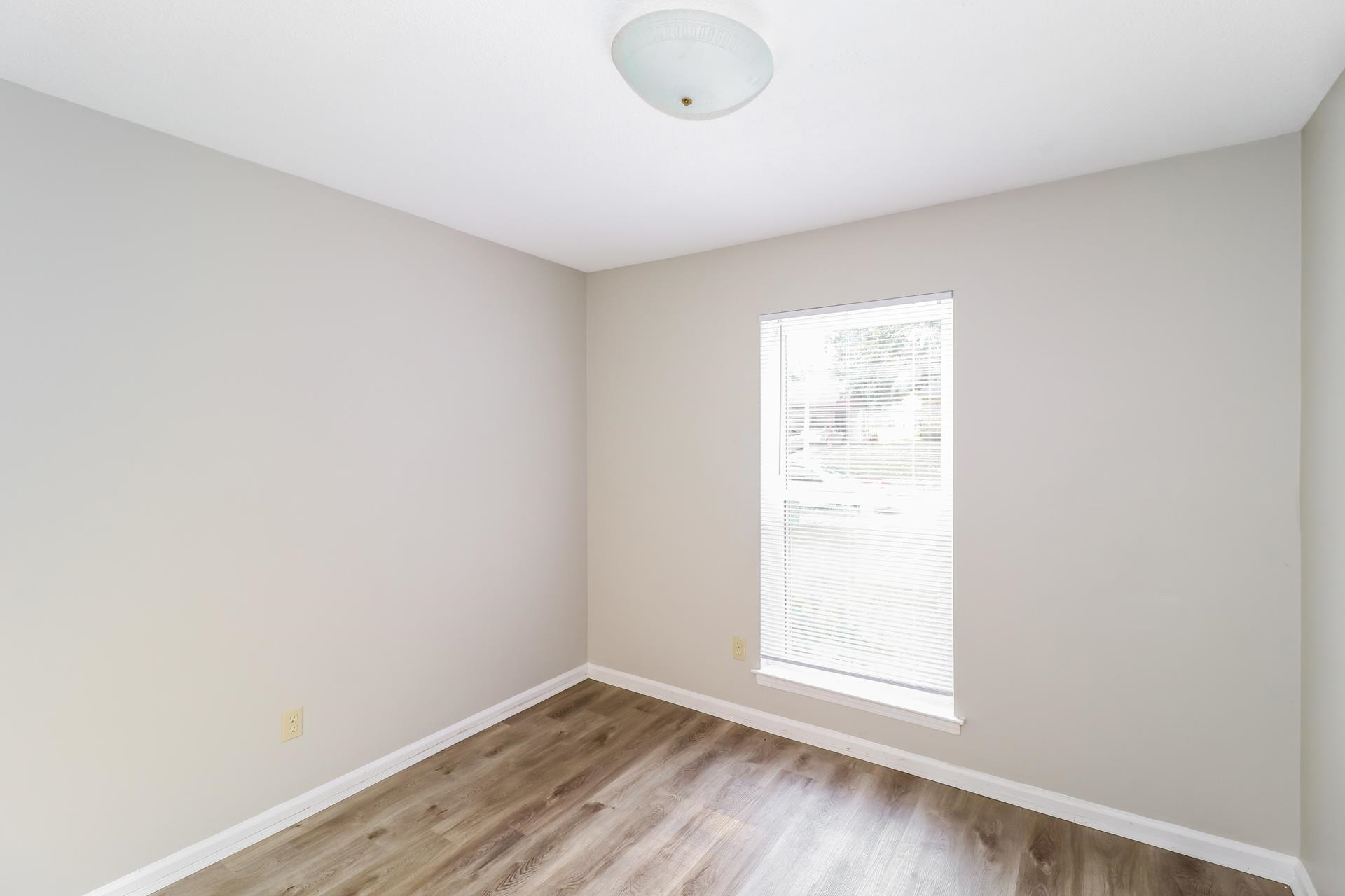 4442 Old Quarry Road Memphis, TN 38118 - Photo 9 of 16 an empty room with wooden floor and windows