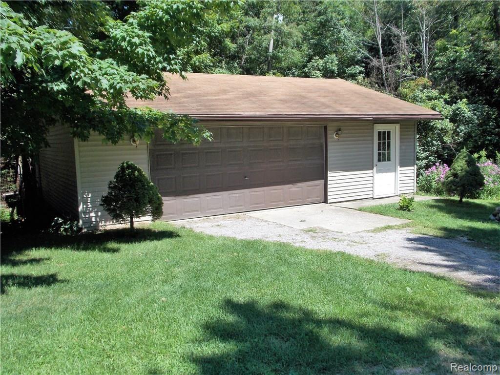 10221 Washburn Road Columbiaville, MI 48421 - Photo 29 of 37 The Detached Garage could keep a couple more cars, or the boat, or motorcycle, lawn mower, quad or whatever else you have. Dad will enjoy the heated workshop in this garage for those winter projects. Dad also will enjoy the work space in the attached garage and even the basement.