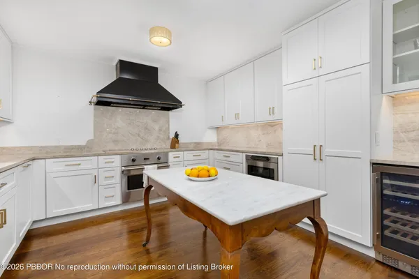 a kitchen with a stove a refrigerator and a stove top oven