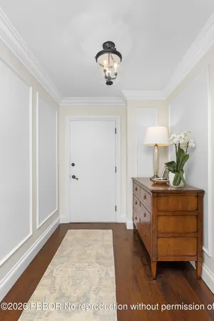 a room with round mirror and cabinets