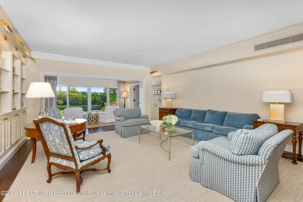 a living room with furniture a lamp and a table