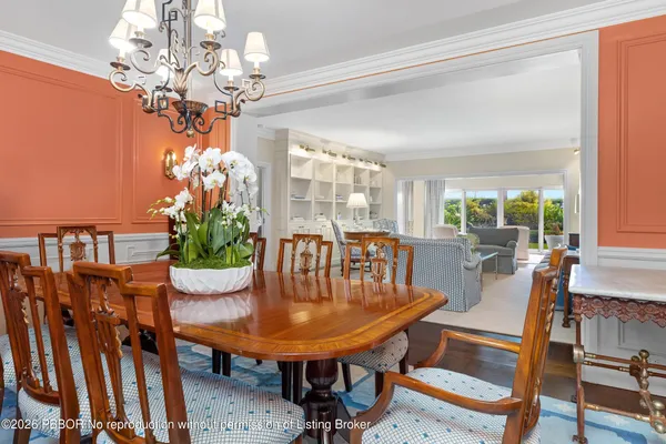 a view of a dining room with furniture and chandelier