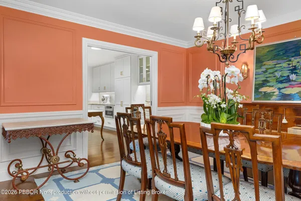 a view of a dining room with furniture and chandelier