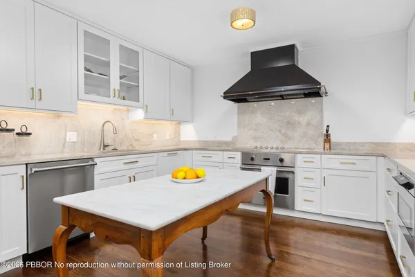 a kitchen with a stove a sink and a refrigerator