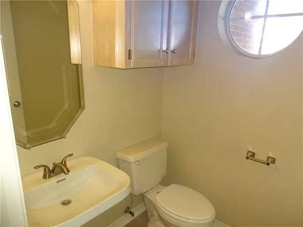 a bathroom with a sink a mirror and a toilet