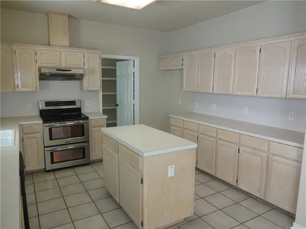 a kitchen with cabinets and appliances