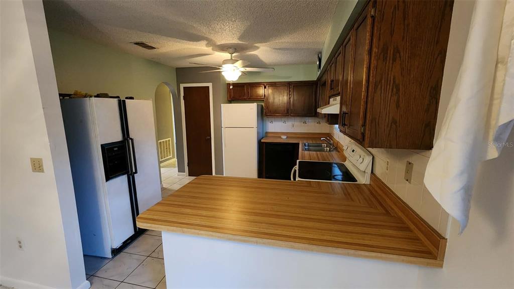62 Silver Lane Ocala, FL 34472 - Photo 12 of 25 a kitchen with stainless steel appliances a refrigerator and a fireplace
