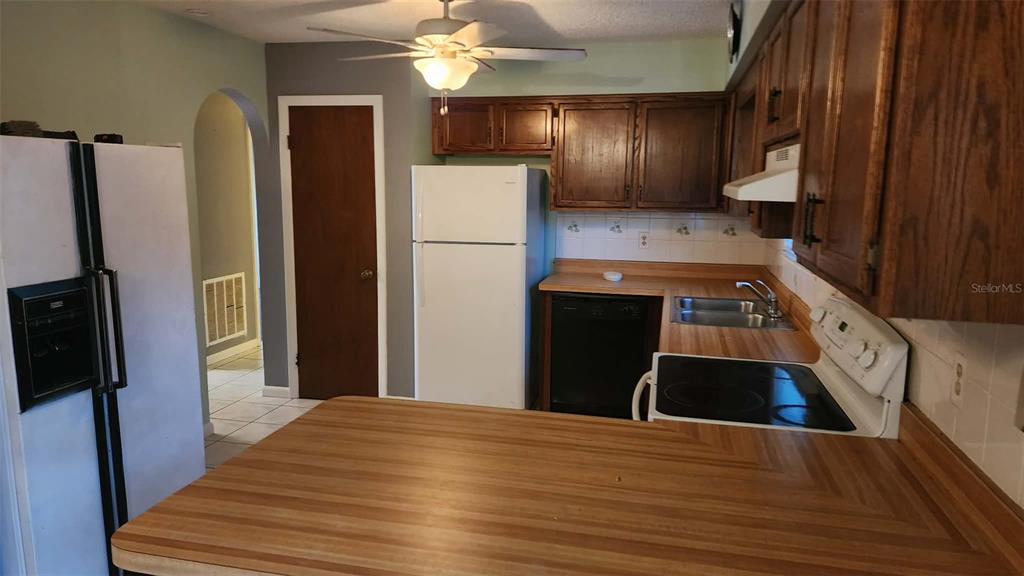 62 Silver Lane Ocala, FL 34472 - Photo 13 of 25 a kitchen with a refrigerator and a sink