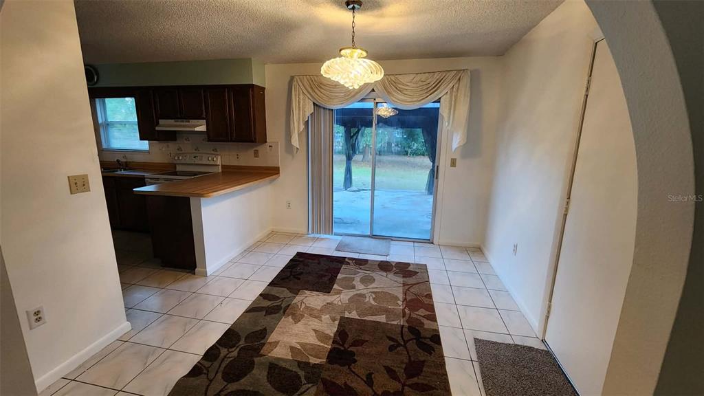 62 Silver Lane Ocala, FL 34472 - Photo 5 of 25 a kitchen with stainless steel appliances granite countertop a sink stove and refrigerator