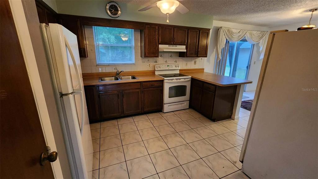 62 Silver Lane Ocala, FL 34472 - Photo 7 of 25 a kitchen with stainless steel appliances granite countertop a refrigerator and a stove top oven