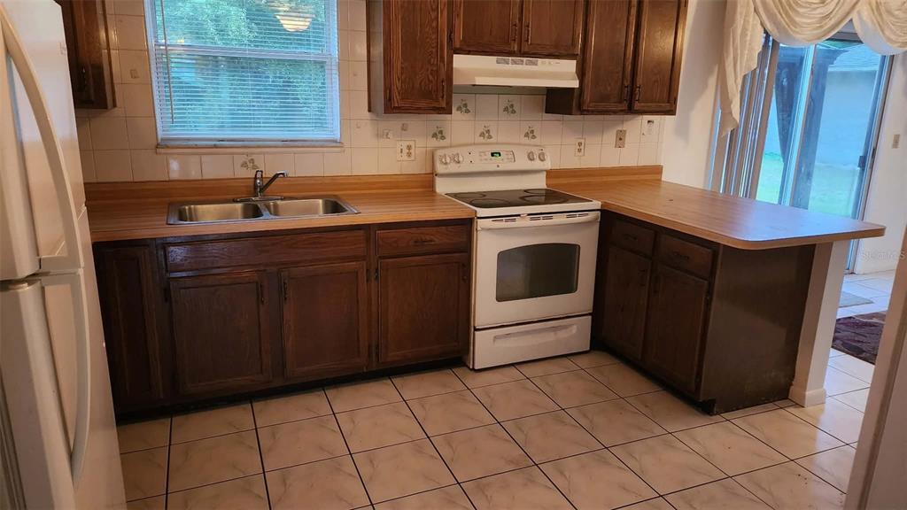 62 Silver Lane Ocala, FL 34472 - Photo 9 of 25 a kitchen with stainless steel appliances a sink stove and cabinets