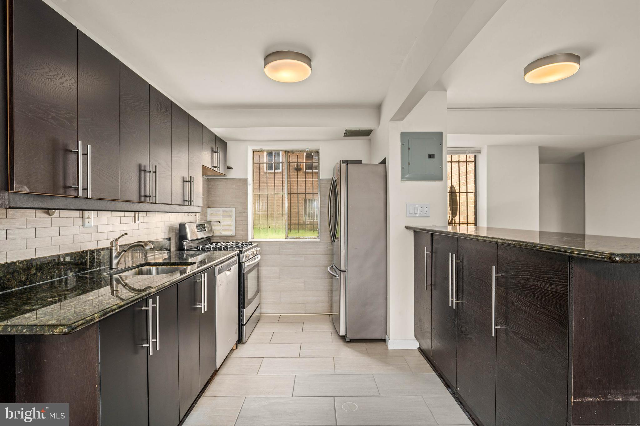 1920 Naylor Road Southeast, Unit T2 Washington, DC 20020 - Photo 11 of 25 a kitchen with stainless steel appliances granite countertop a refrigerator and a sink