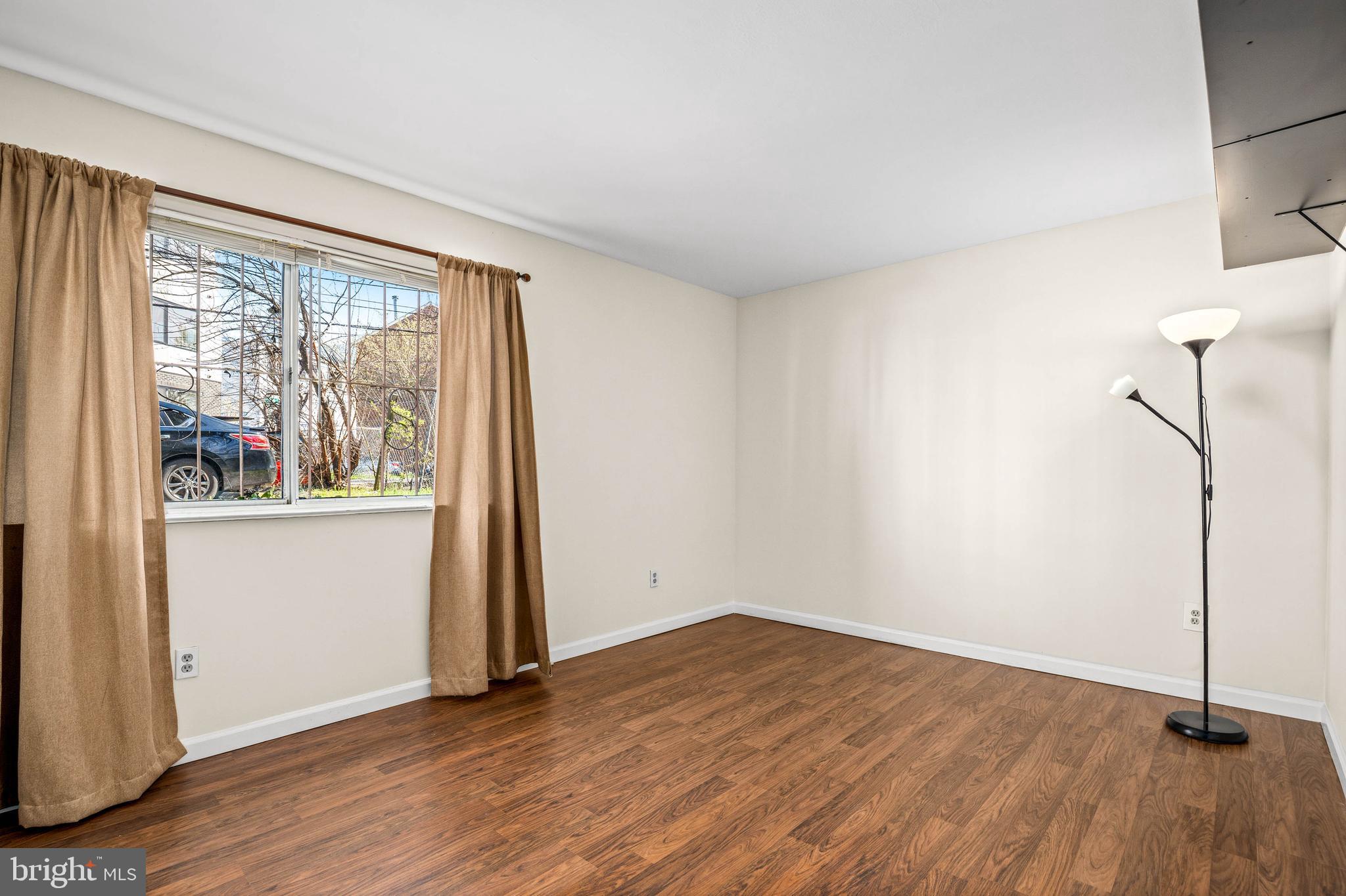 1920 Naylor Road Southeast, Unit T2 Washington, DC 20020 - Photo 14 of 25 an empty room with wooden floor and windows