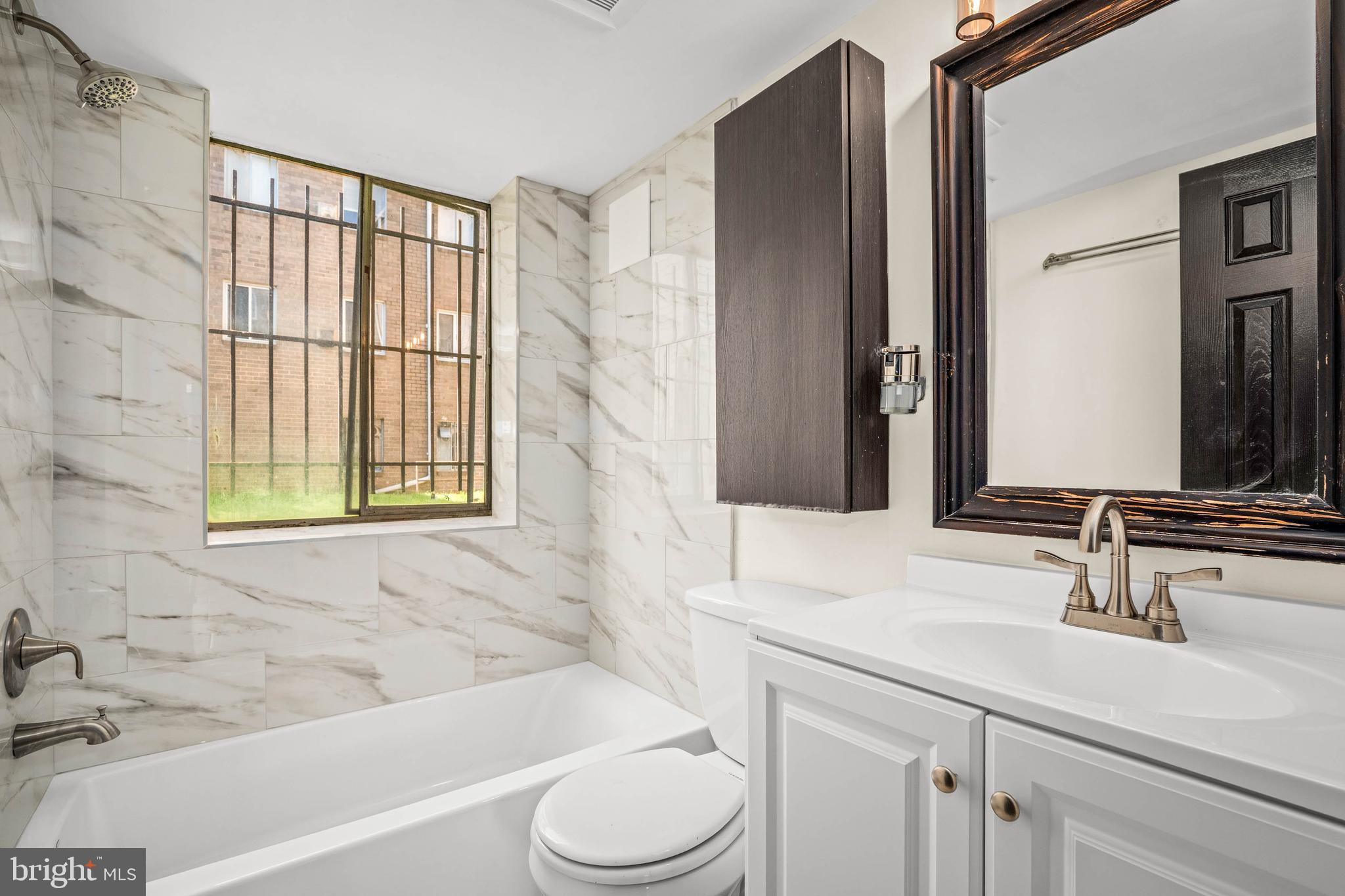 1920 Naylor Road Southeast, Unit T2 Washington, DC 20020 - Photo 18 of 25 a bathroom with a sink toilet and shower