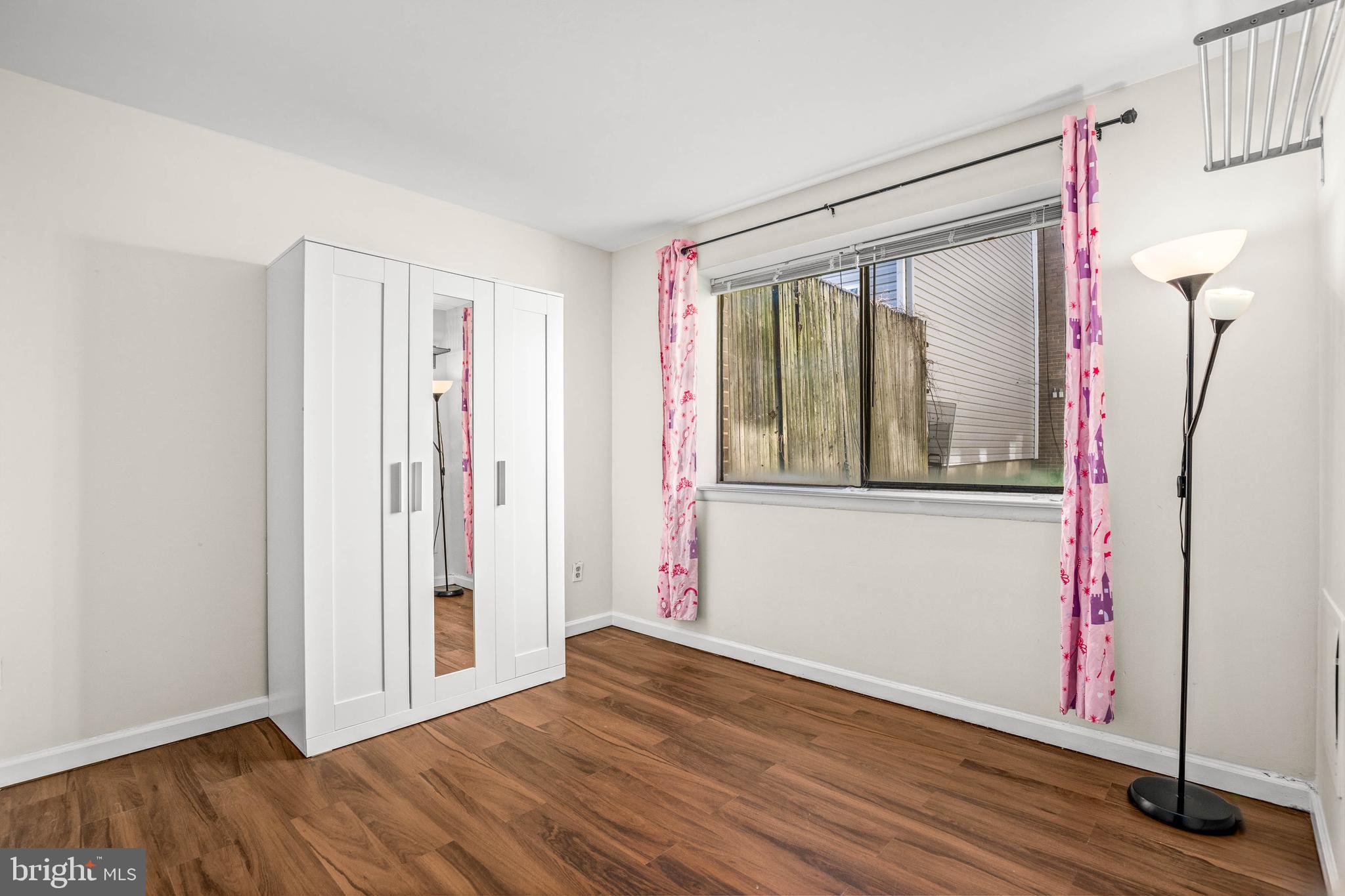 1920 Naylor Road Southeast, Unit T2 Washington, DC 20020 - Photo 19 of 25 a view of an empty room with wooden floor and a window