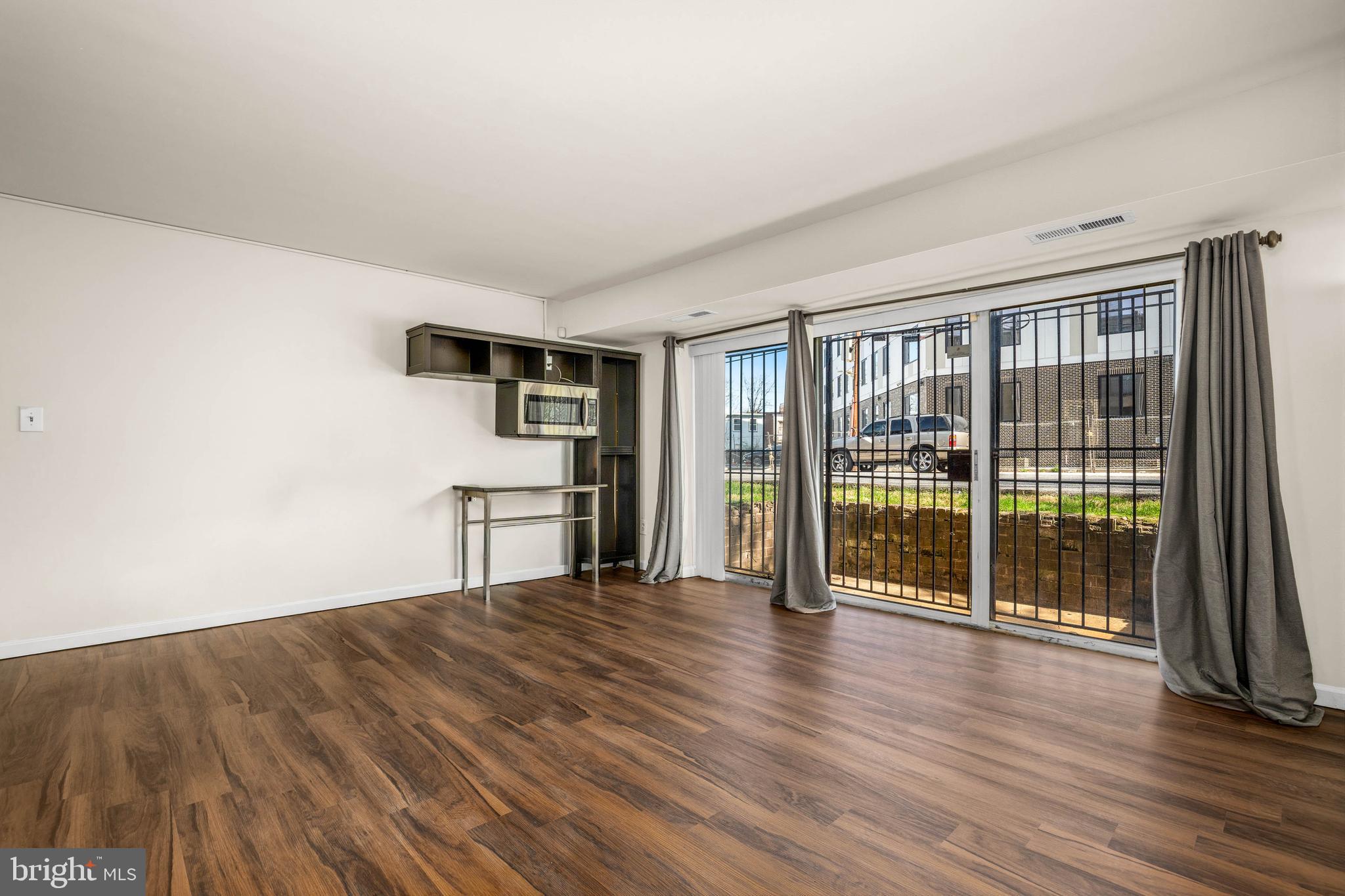 1920 Naylor Road Southeast, Unit T2 Washington, DC 20020 - Photo 5 of 25 a living room with stainless steel appliances wooden floor and a window