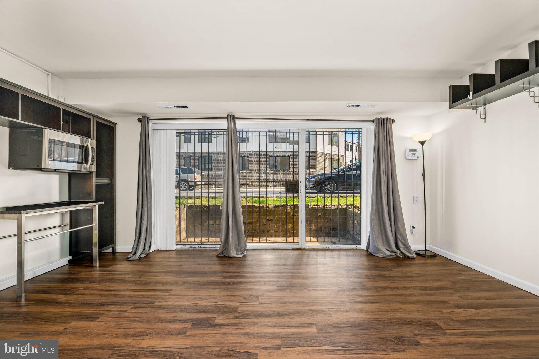 1920 Naylor Road Southeast, Unit T2 Washington, DC 20020 - Photo 6 of 25 a view of an empty room with wooden floor and a window