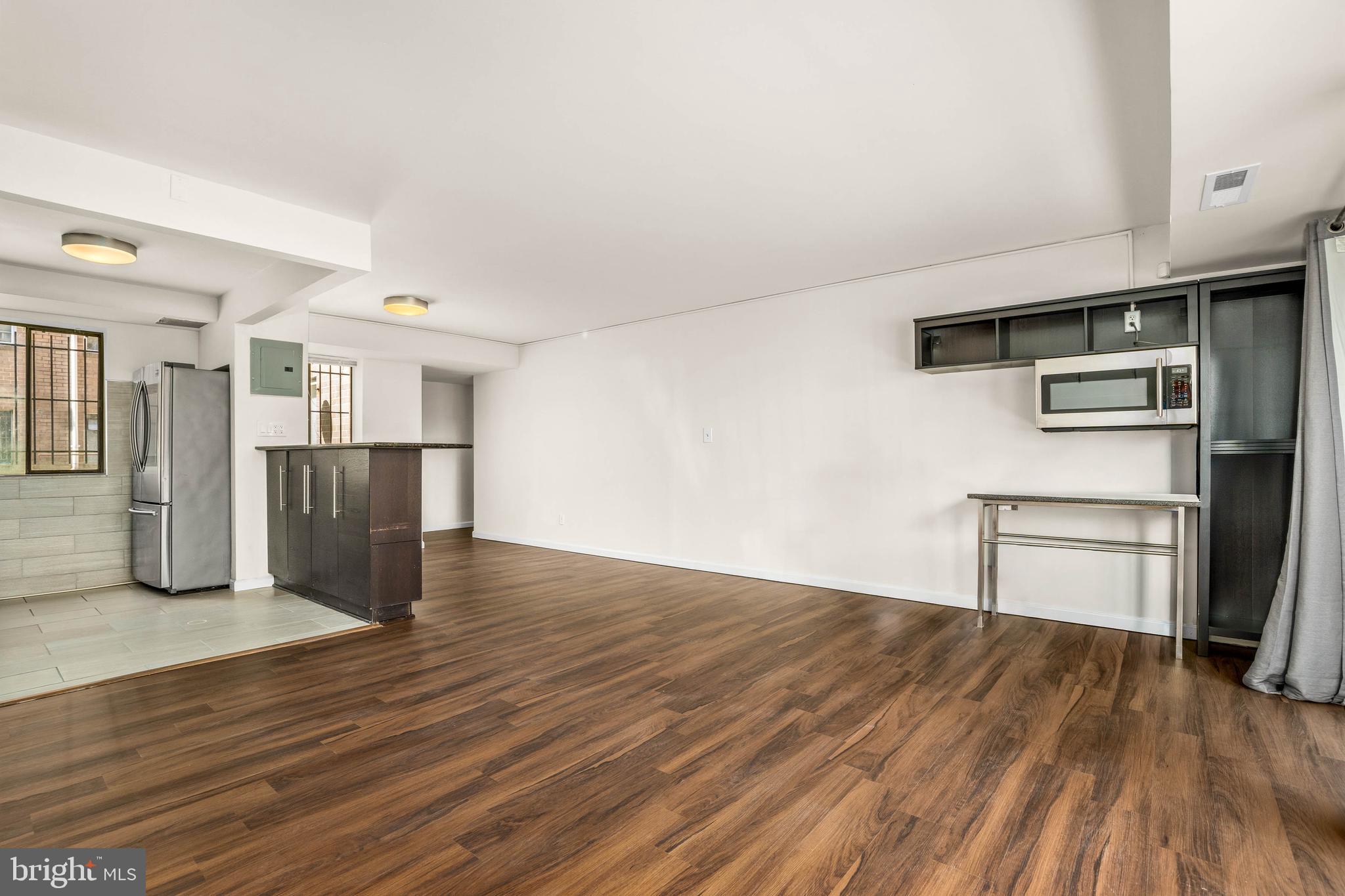 1920 Naylor Road Southeast, Unit T2 Washington, DC 20020 - Photo 8 of 25 a view of empty room with wooden floor and kitchen