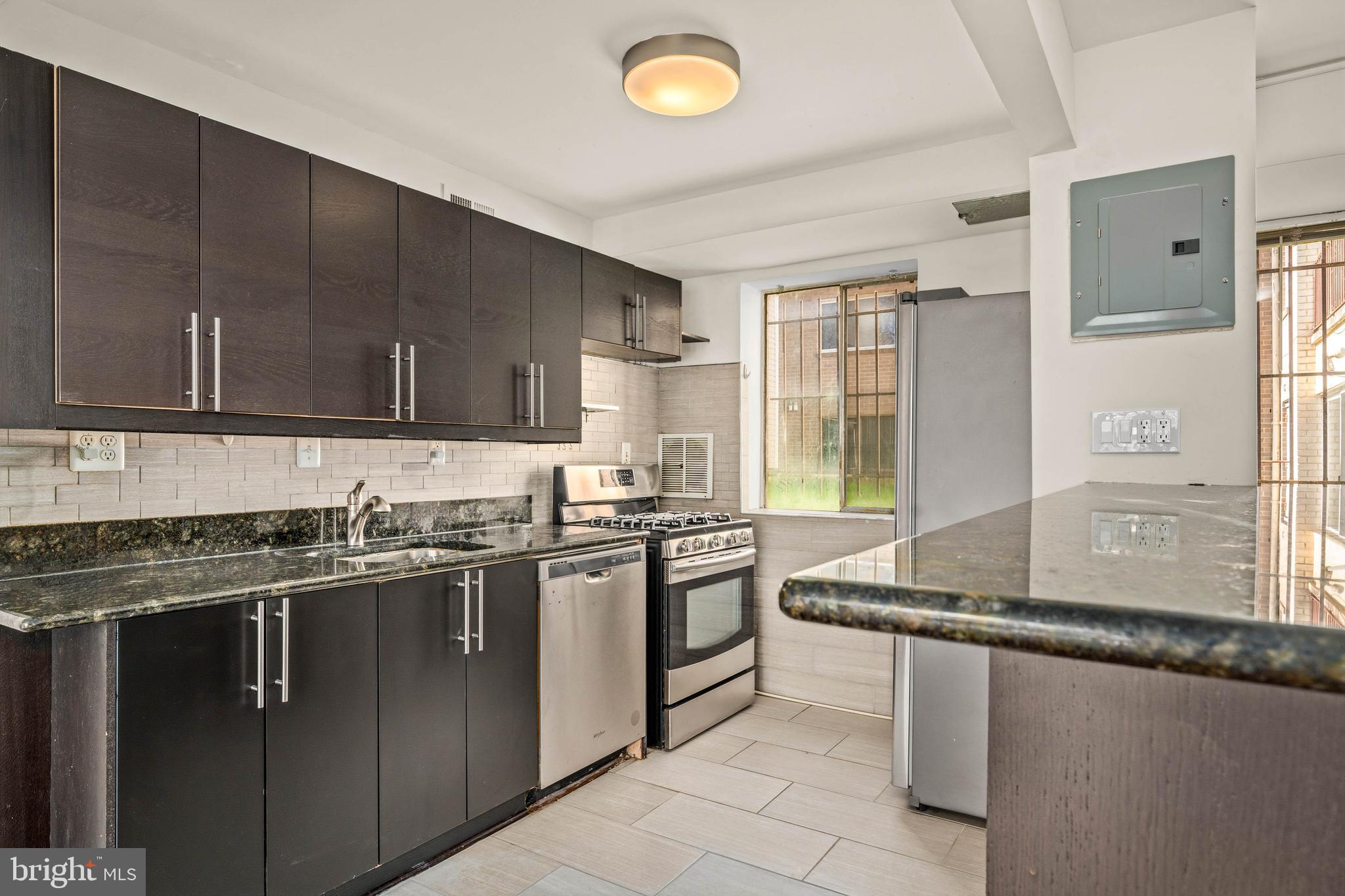 1920 Naylor Road Southeast, Unit T2 Washington, DC 20020 - Photo 10 of 25 a kitchen with stainless steel appliances granite countertop a sink stove and cabinets