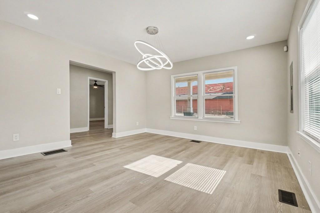 1515 Jonesboro Road Southeast Atlanta, GA 30315 - Photo 13 of 32 an empty room with wooden floor and windows