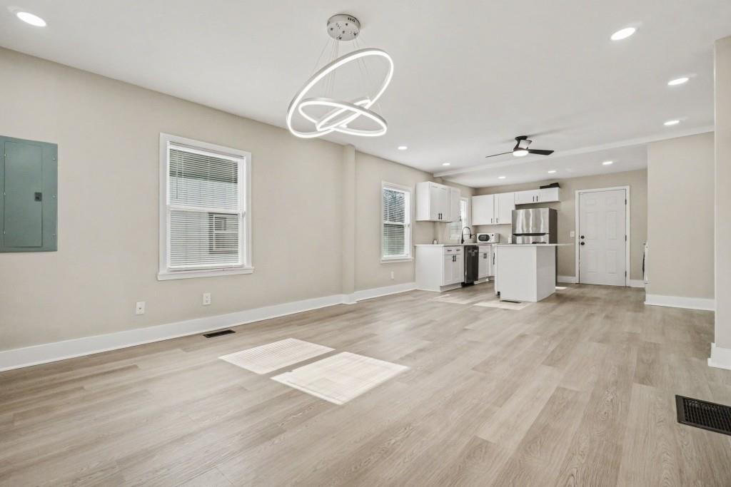 1515 Jonesboro Road Southeast Atlanta, GA 30315 - Photo 15 of 32 an empty room with wooden floor and windows