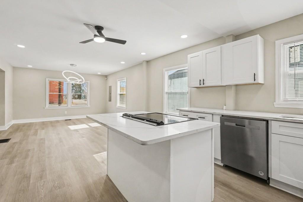 1515 Jonesboro Road Southeast Atlanta, GA 30315 - Photo 16 of 32 a kitchen with a stove sink and cabinets