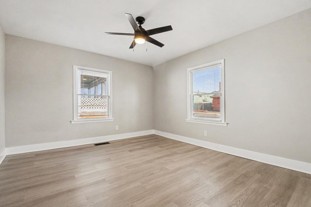 1515 Jonesboro Road Southeast Atlanta, GA 30315 - Photo 21 of 32 a view of a big room with wooden floor and windows