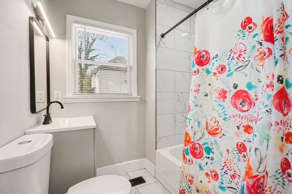 1515 Jonesboro Road Southeast Atlanta, GA 30315 - Photo 24 of 32 a bathroom with a sink and a shower curtain