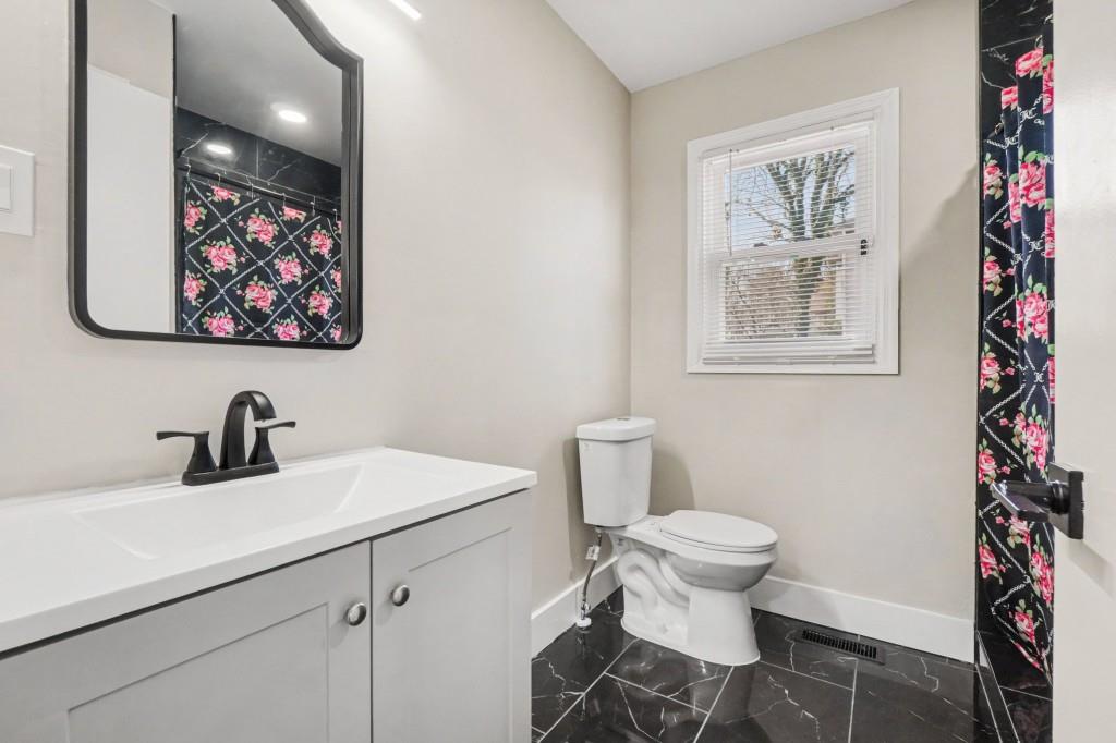 1515 Jonesboro Road Southeast Atlanta, GA 30315 - Photo 29 of 32 a bathroom with a toilet sink and mirror