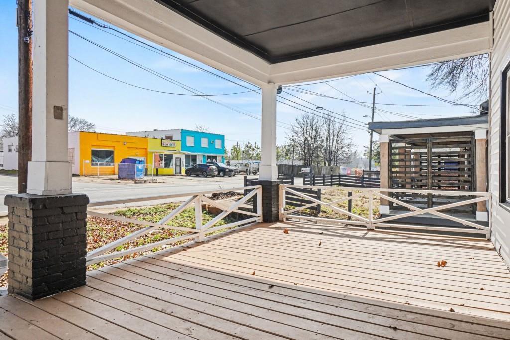 1515 Jonesboro Road Southeast Atlanta, GA 30315 - Photo 8 of 32 a view of a balcony with wooden floor and outdoor seating
