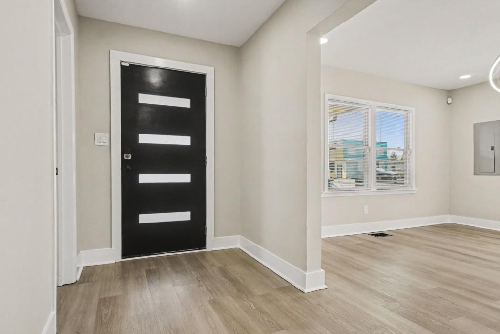 1515 Jonesboro Road Southeast Atlanta, GA 30315 - Photo 10 of 32 an empty room with wooden floor closet and windows