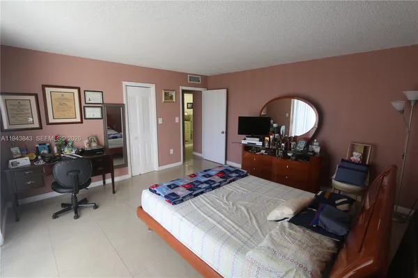 a bedroom with a bed and a table