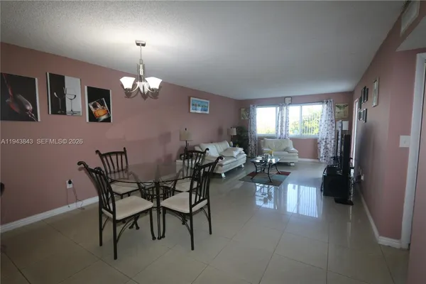 a view of a dining room with furniture and chandelier
