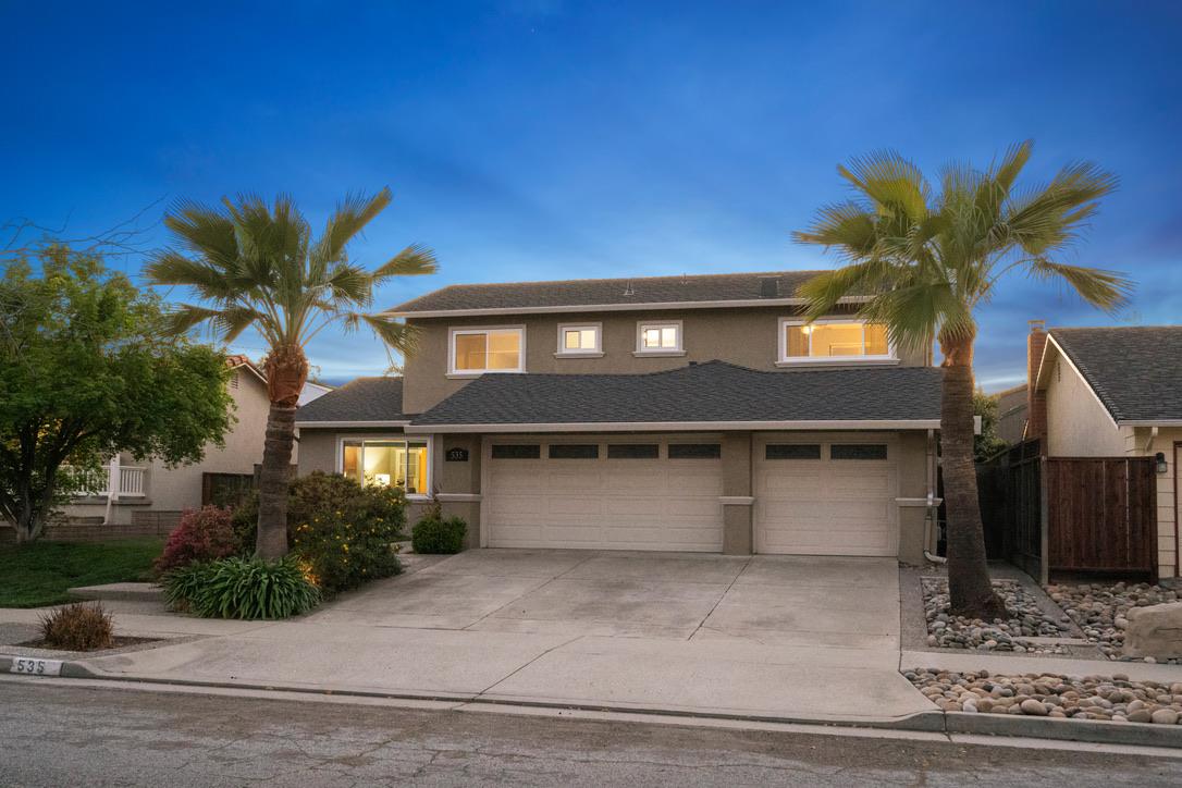 a house that has a palm tree in front of it