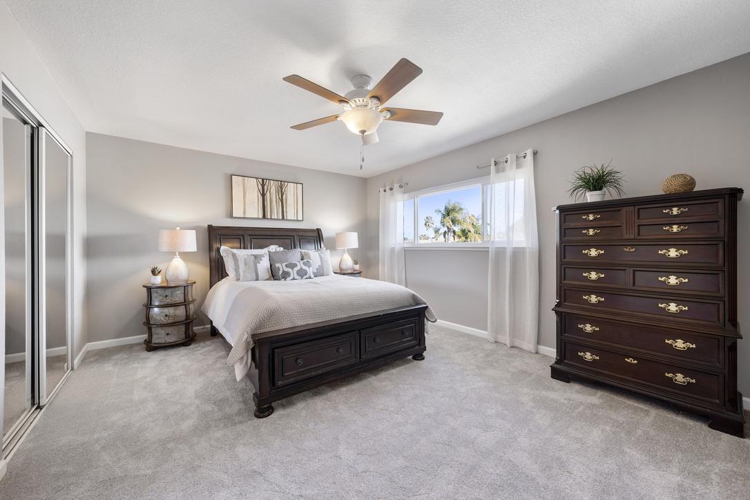 535 Hyde Park Drive San Jose, CA 95136 - Photo 12 of 28 a bedroom with a bed and a chandelier
