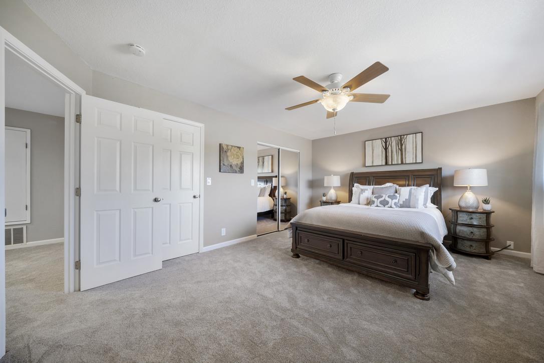 535 Hyde Park Drive San Jose, CA 95136 - Photo 14 of 28 a spacious bedroom with a bed and a chandelier