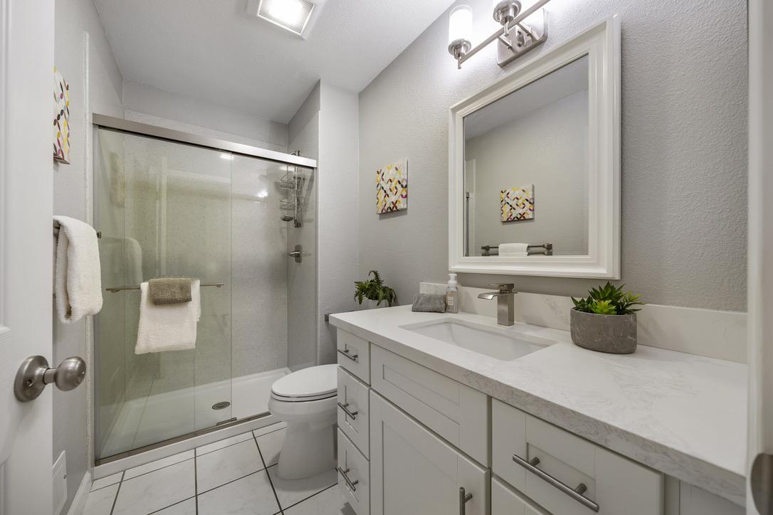 535 Hyde Park Drive San Jose, CA 95136 - Photo 16 of 28 a bathroom with a shower sink vanity mirror and toilet