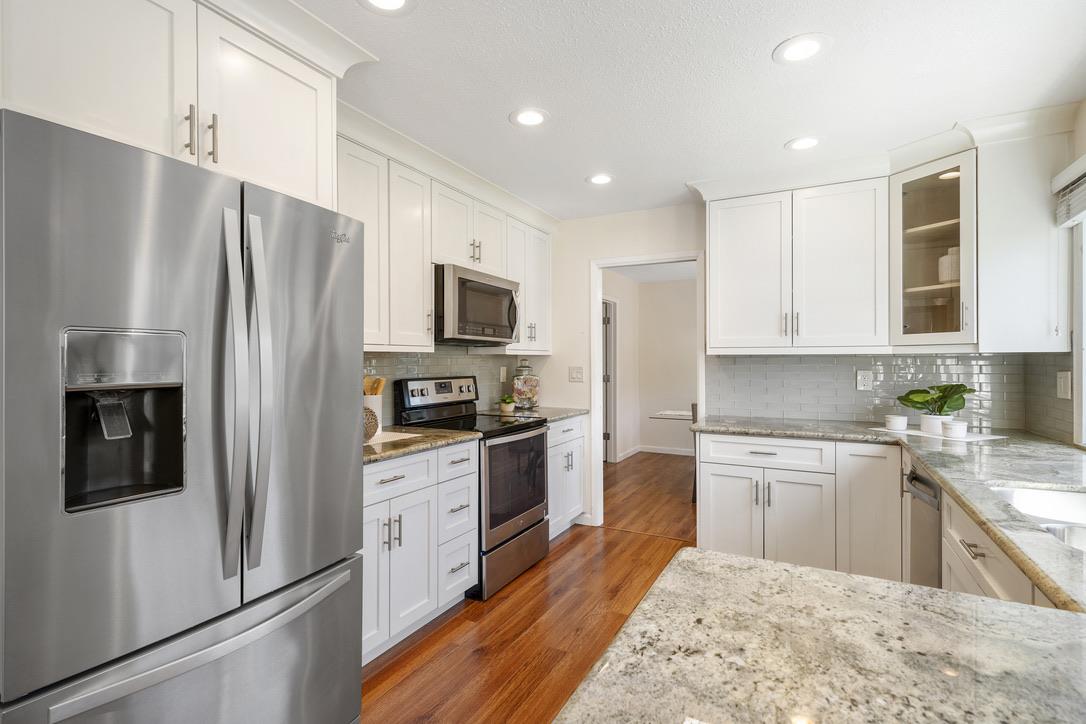 535 Hyde Park Drive San Jose, CA 95136 - Photo 5 of 28 a kitchen with stainless steel appliances granite countertop a refrigerator a stove microwave and sink