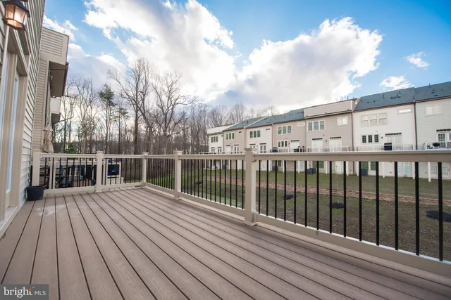 a terrace with wooden floor and fence