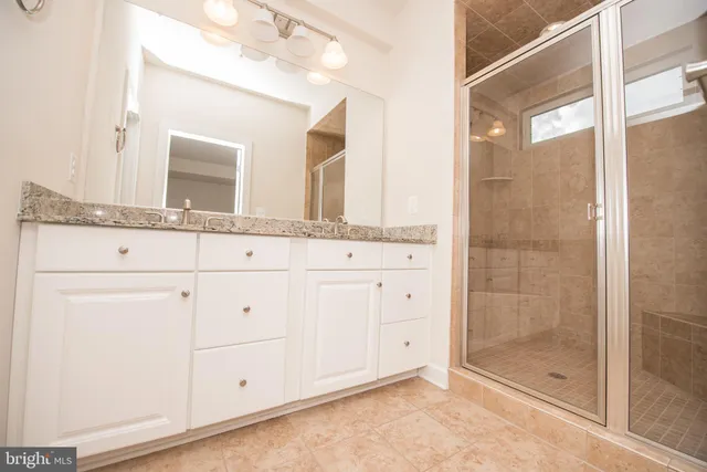 a bathroom with a granite countertop sink mirror and