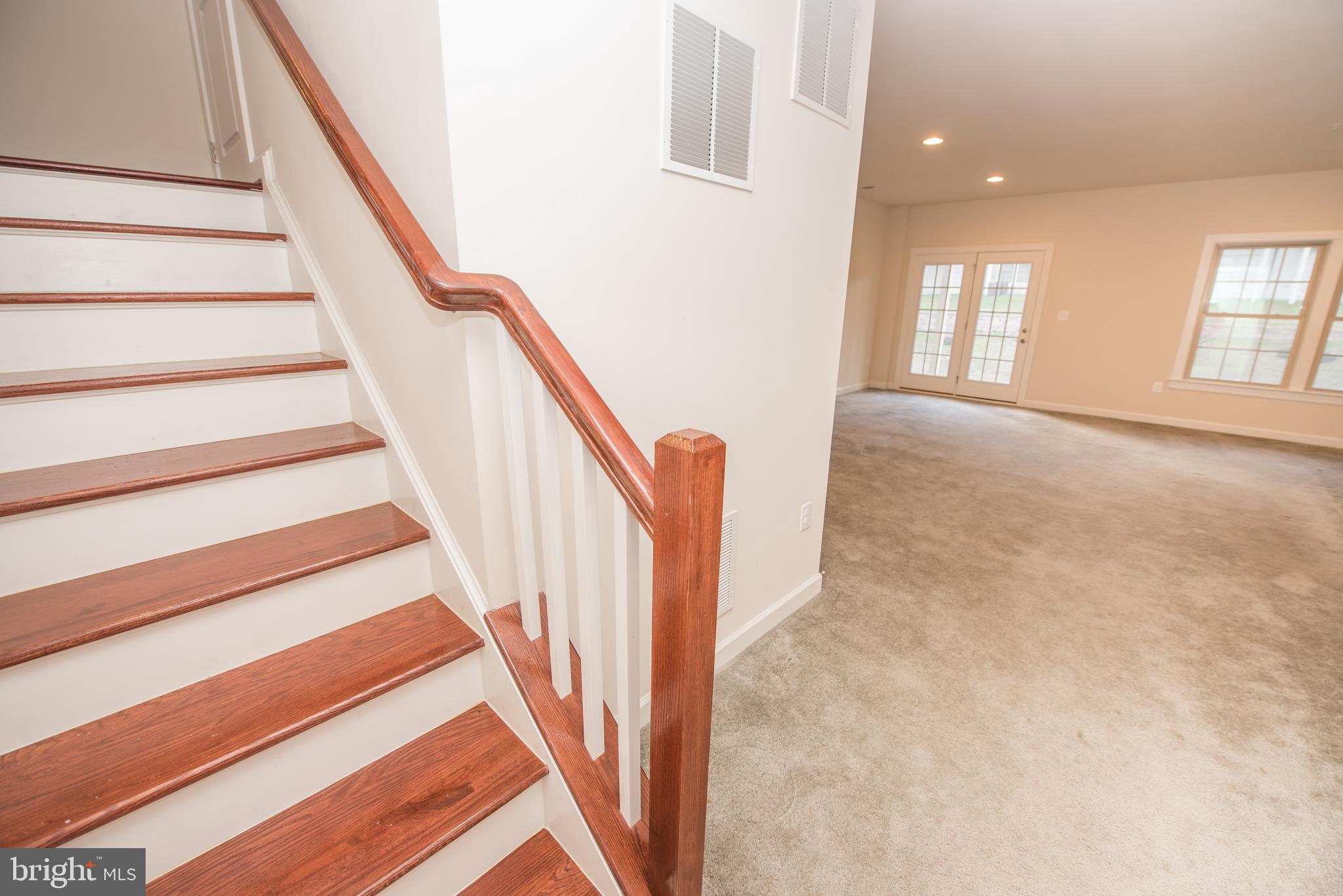 7444 Burnside Way Hanover, MD 21076 - Photo 41 of 46 a view of entryway and hall with wooden floor