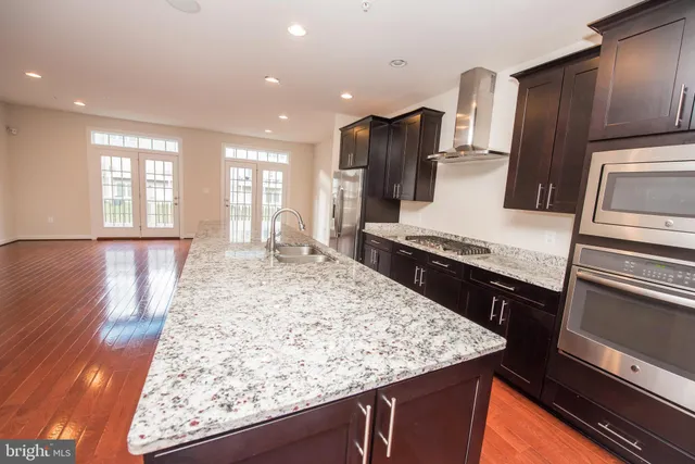 a kitchen with a sink stove and refrigerator