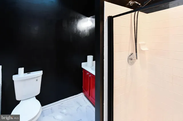 a bathroom with a toilet and a shower