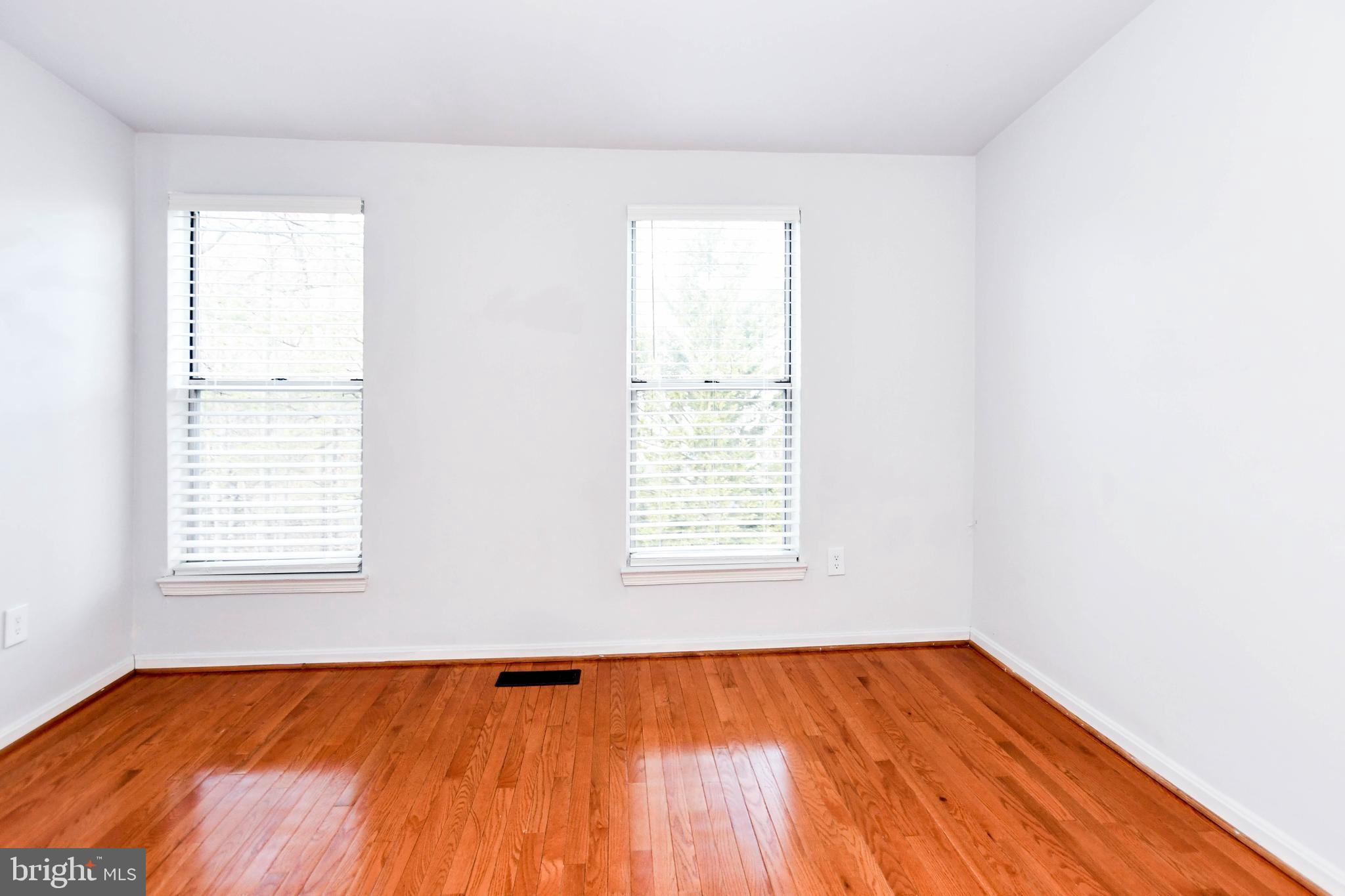 120 Forests Edge Place Laurel, MD 20724 - Photo 14 of 23 an empty room with wooden floor and windows