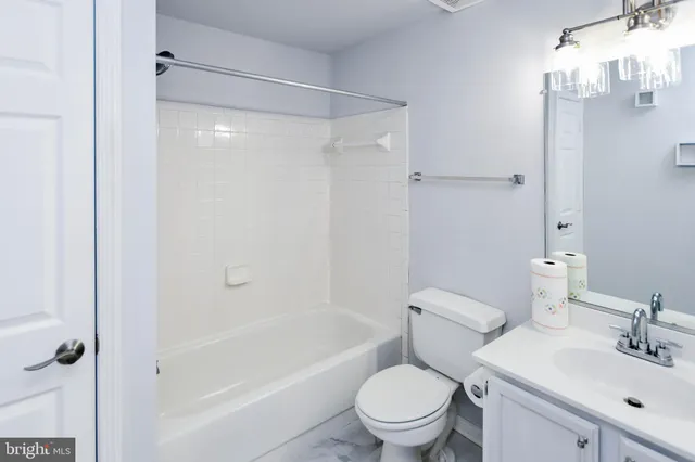 a white toilet sitting next to a bath tub