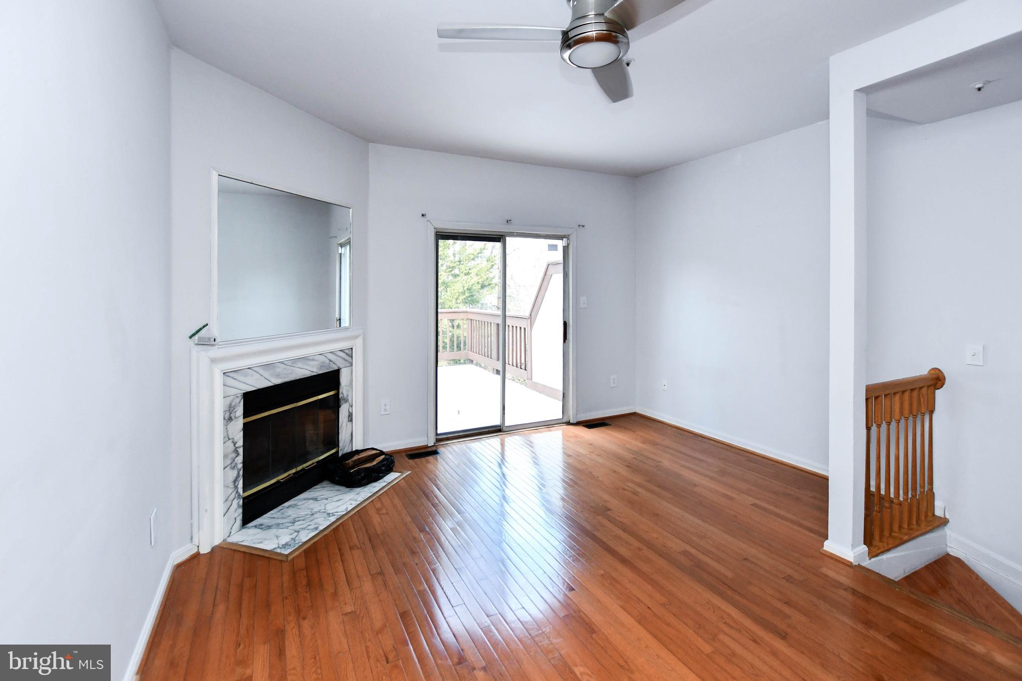 120 Forests Edge Place Laurel, MD 20724 - Photo 3 of 23 a view of an empty room with wooden floor fireplace and a window