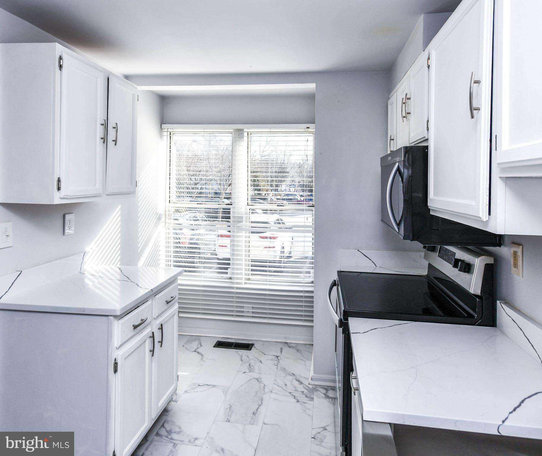 120 Forests Edge Place Laurel, MD 20724 - Photo 7 of 23 a kitchen with a cabinets and a stove top oven