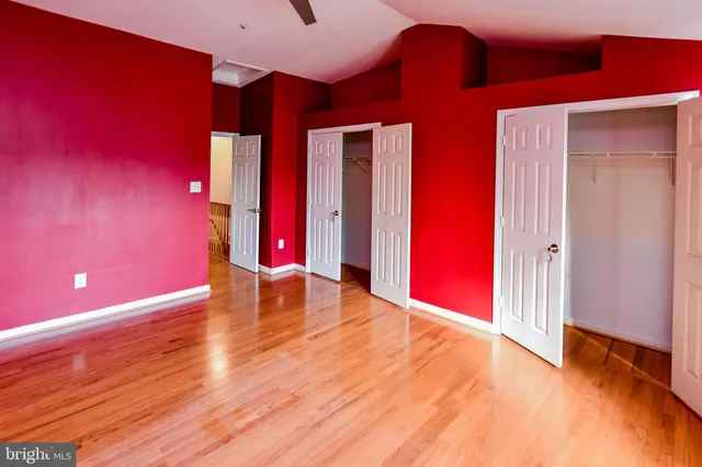 a view of an empty room with wooden floor
