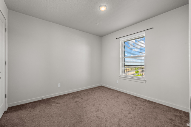 1700 South Sandhill Road West, Unit E 301 Orem, UT 84058 - Photo 13 of 20 Neutral-toned room featuring a single window with blinds, recessed ceiling lighting, textured carpet, and a white interior door